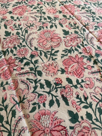 House of Mulmul - Cotton Table Cloth Round. Close-up of floral fabric with pink and green pattern