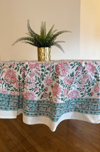 House of Mulmul - Cotton Table Cloth Round. Floral patterned tablecloth on a table with a plant in the background