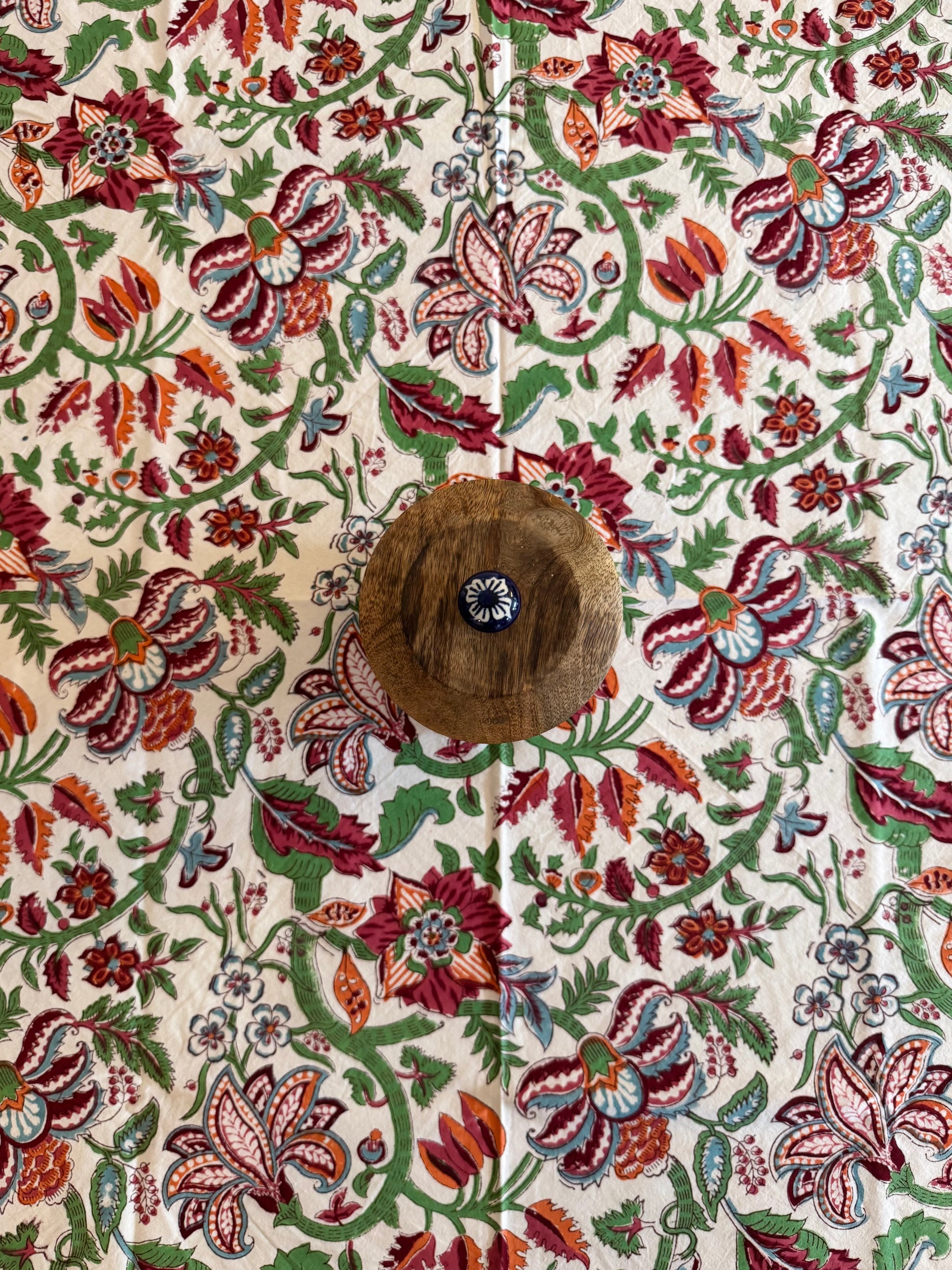 House of Mulmul - Cotton Table Cloth Round. Close-up of a table cloth with a floral pattern and a button.