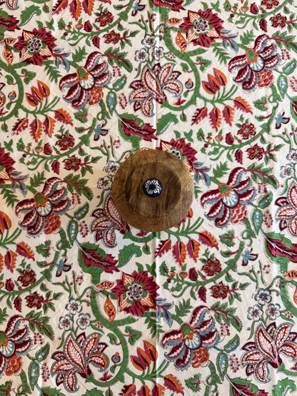 House of Mulmul - Cotton Table Cloth Round. Close-up of a table cloth with a floral pattern and a button.