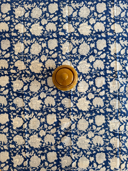 House of Mulmul - Cotton Table Cloth Round. Floral patterned fabric with a wooden knob on a blue background
