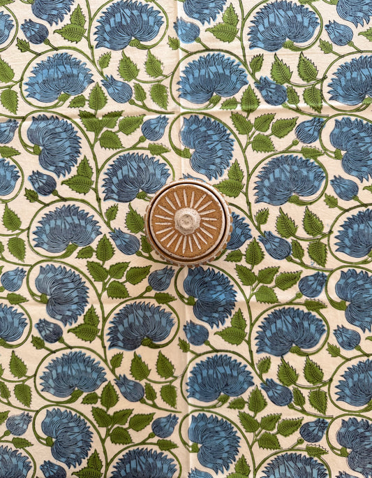 House of Mulmul - Cotton Table Cloth Round with green leaves, blue flower and white background pattern.