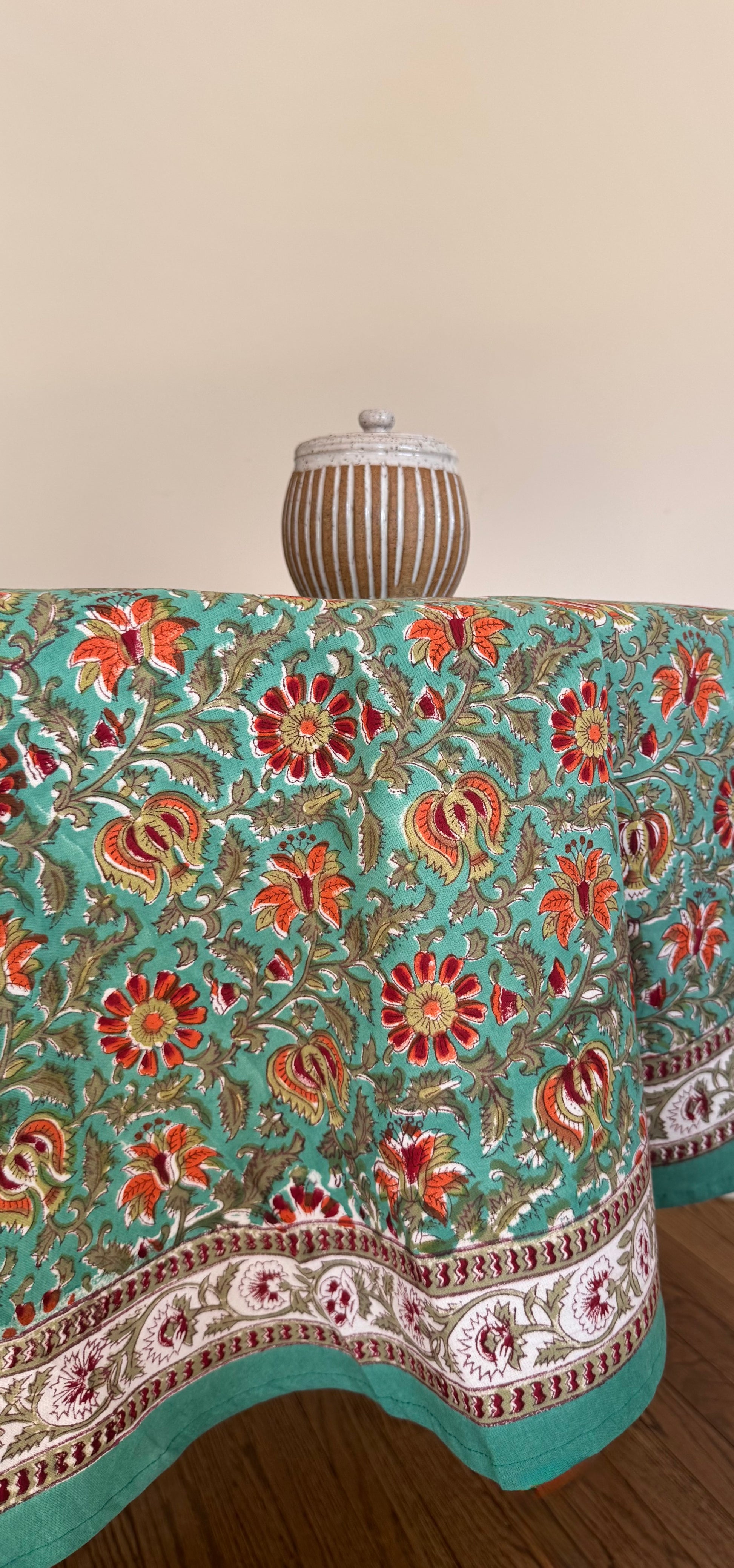 House of Mulmul - Cotton Table Cloth Round. Decorative tablecloth with floral pattern on a wooden table