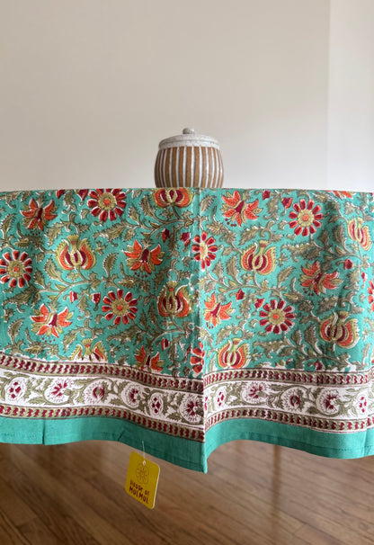 House of Mulmul - Cotton Table Cloth Round. Decorative tablecloth with floral pattern on a wooden table