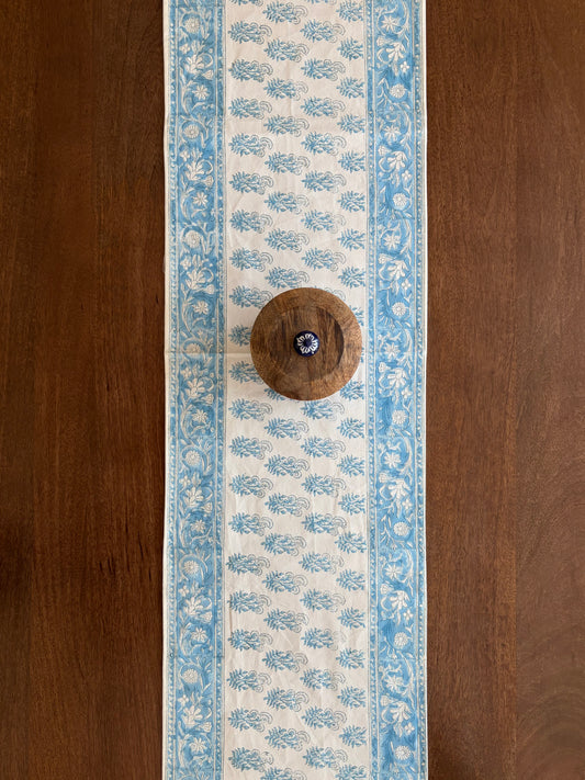 House of Mulmul - Cotton Blockprinted Table Runner. Decorative table runner with blue floral pattern on a wooden surface