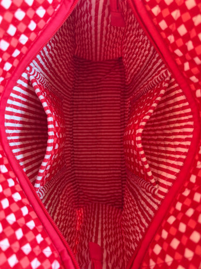 House of Mulmul - Cotton Tote Bags. Close-up of a red and white patterned bag interior with a zippered opening and two side pockets.