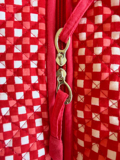 House of Mulmul - Cotton Tote Bags. Close-up of a quilted red and white checkered fabric bag with a red zipper and gold-tone metal pull tabs.