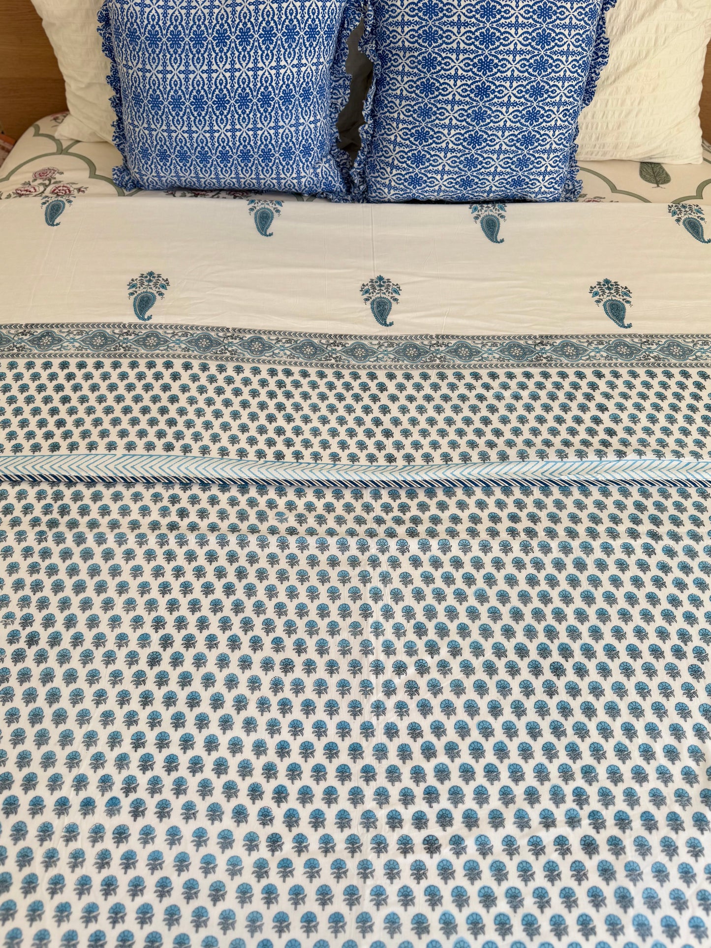 House of Mulmul - Coverlet Dohar blanket. Bedroom with reversible cotton coverlet blanket. Muslin dohar with boota paisley leaf and blue and grey colors, white background.