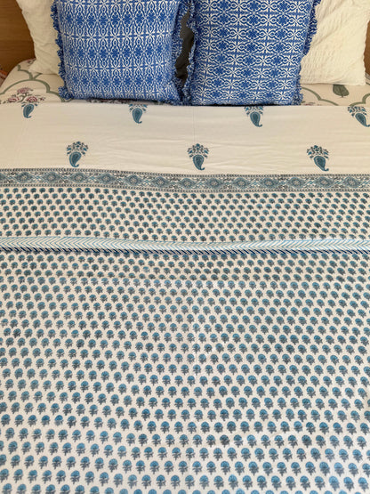 House of Mulmul - Coverlet Dohar blanket. Bedroom with reversible cotton coverlet blanket. Muslin dohar with boota paisley leaf and blue and grey colors, white background.