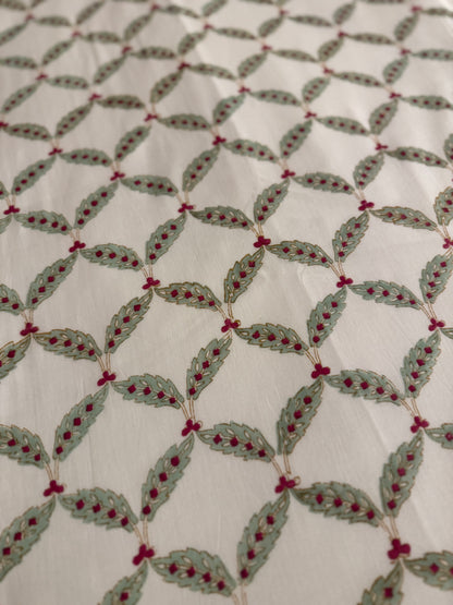 House of Mulmul - Coverlet Dohar, cotton blanket, muslin blanket, mulmul dohar. Decorative handblock printed fabric with patterned fabric with green leaves and red berries on a white background