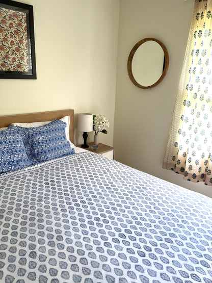 House of Mulmul - Cotton Coverlets (Dohar). Bedroom with patterned bedding, pillows, and decor elements.