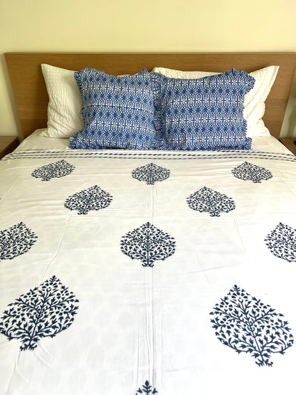 House of Mulmul - Cotton Coverlets (Dohar). Bed with white comforter and blue patterned pillows