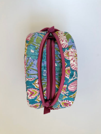 House of Mulmul - Handblock Printed Travel Makeup Quilted Pouch set. A small zippered cosmetic pouch with a colorful floral print on a teal background and a dusty rose zipper, shown against a plain off-white background.
