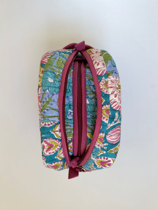 House of Mulmul - Handblock Printed Travel Makeup Quilted Pouch set. A small zippered cosmetic pouch with a colorful floral print on a teal background and a dusty rose zipper, shown against a plain off-white background.