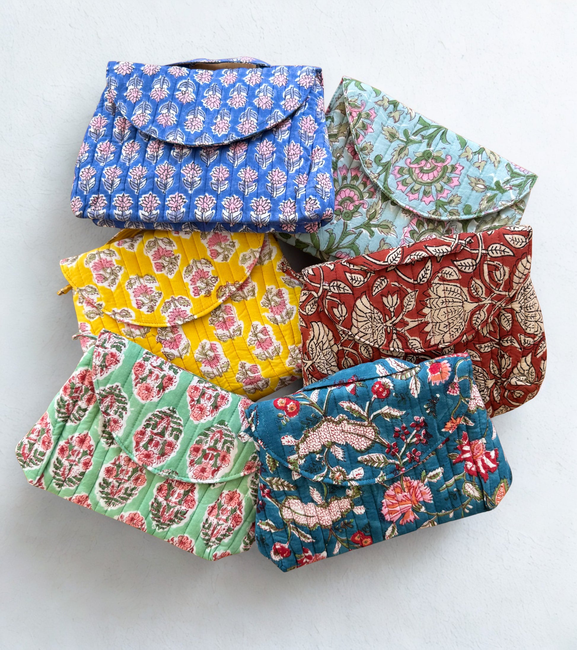 House of Mulmul - Quilted Foldable Travel Makeup pouch. Set of colorful floral-patterned makeup pouches on a white background