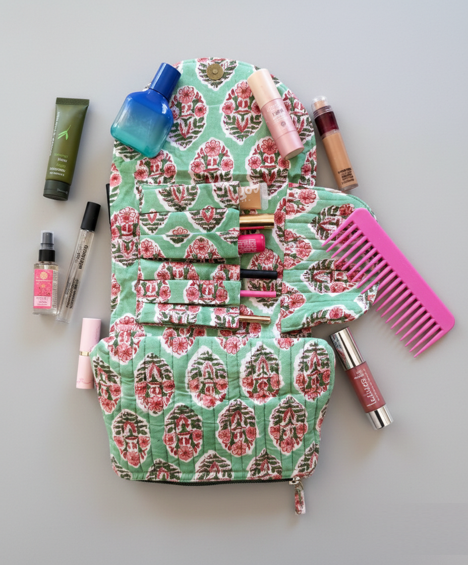 House of Mulmul - Quilted Foldable Travel Makeup pouch. Patterned toiletry bag with various cosmetic items on a light gray background