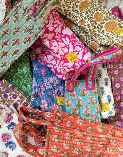House of Mulmul - Quilted Wine Tote Bags. Collection of colorful patterned wine bags with visible brand labels.