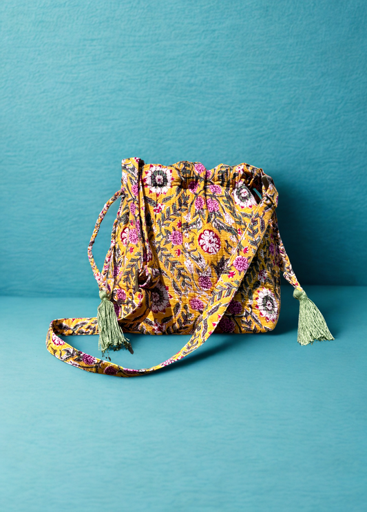 House of Mulmul - Garden Wayfarer Bucket Bag, Cotton bag, Crossbody sling bag. Floral patterned drawstring bag with tassels on a teal background