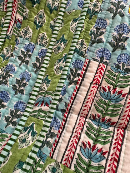 House of Mulmul - Cotton Tote Bag. Close-up of a tote bag with floral and striped patterns in green, blue, and red.