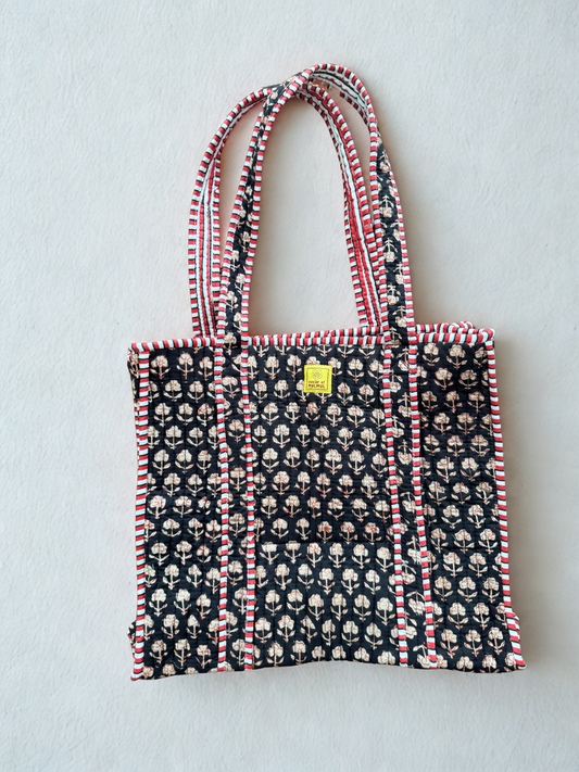 House of Mulmul - Cotton Tote Bag. Black Tote bag with pattern and red accents on a light gray background