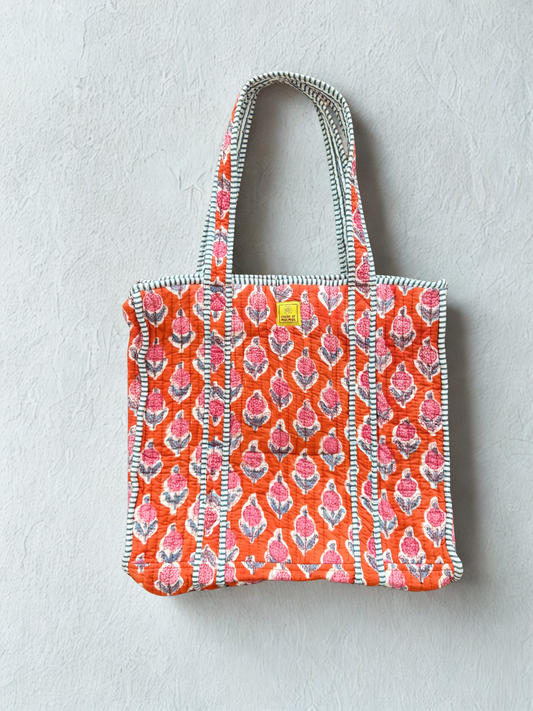 House of Mulmul - Cotton Tote Bag. Tote bag with pink and orange pattern on a light gray background