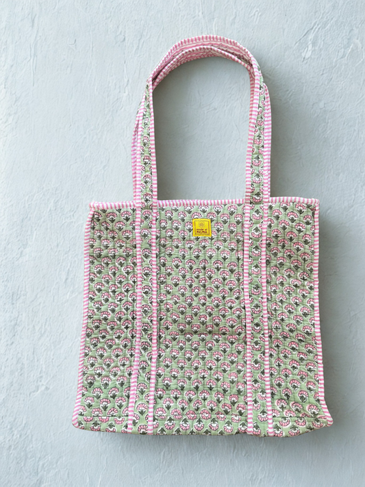 House of Mulmul - Cotton Tote Bag. Floral patterned tote bag with pink trim on a light green background