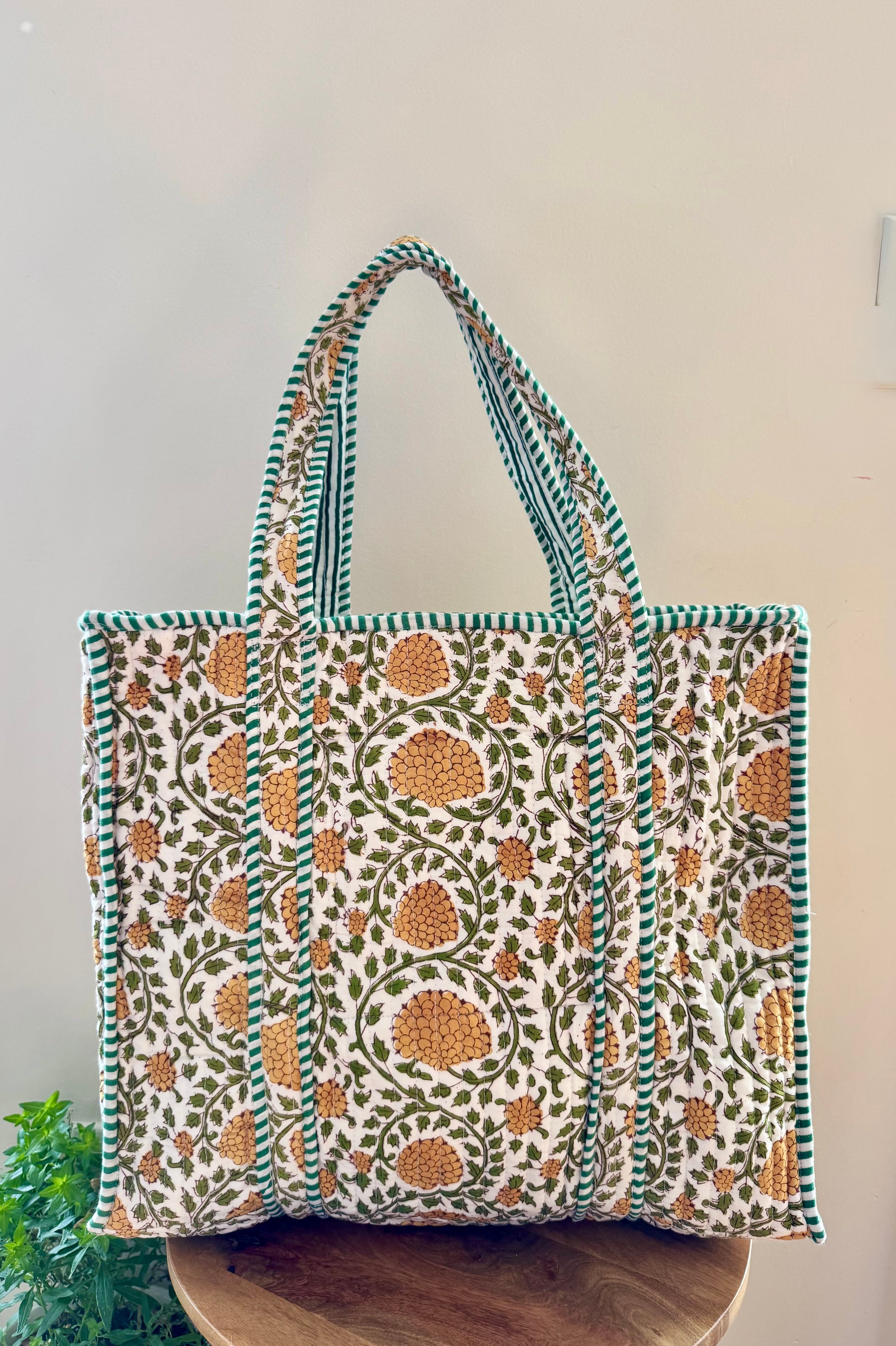 House of Mulmul - Cotton Tote Bag, Travel Bag. Patterned tote bag on a wooden surface with a white background